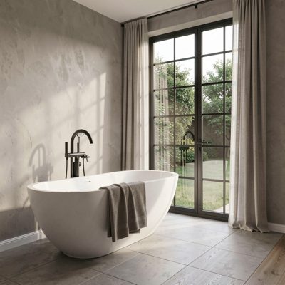 a bathroom with a freestanding tub and large window
