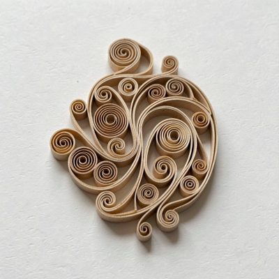 a paper quilling design taking shape