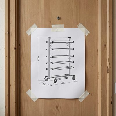 a rack elevation diagram printed and taped to a door