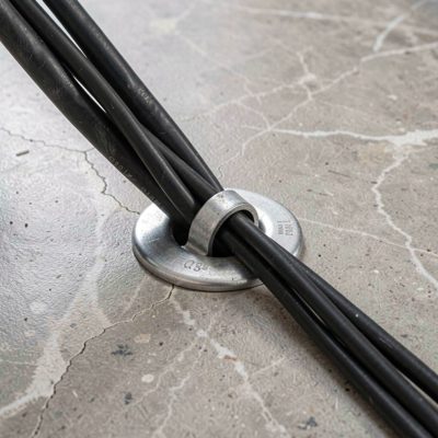 a floor grommet with a bundle of cables passing through