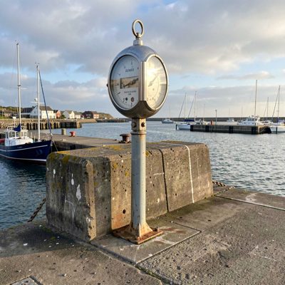 a tide gauge on a harbour wall