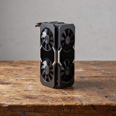 a dual slot graphics card standing on end on a bench, no logos, no text, no branding
