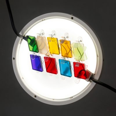 a set of coloured gels clipped to a light