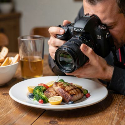 a photographer photographing a plate of food
