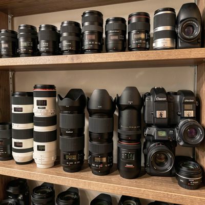 a shelf of camera bodies and lenses