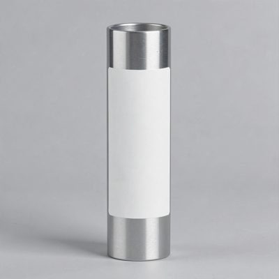 an aluminium tube standing upright with a blank white label