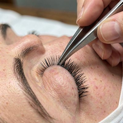 eyelash extensions being applied with tweezers