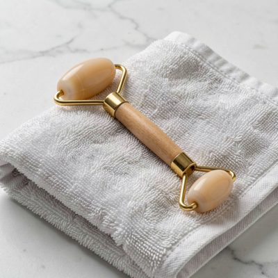 a facial roller resting on a folded towel