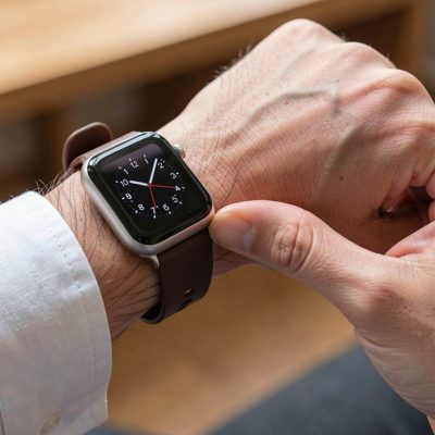 a smartwatch being fastened onto a wrist