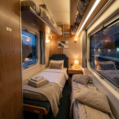a night train compartment with a made up berth